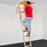 Modern loft ladder with safety rails installed in residential attic space